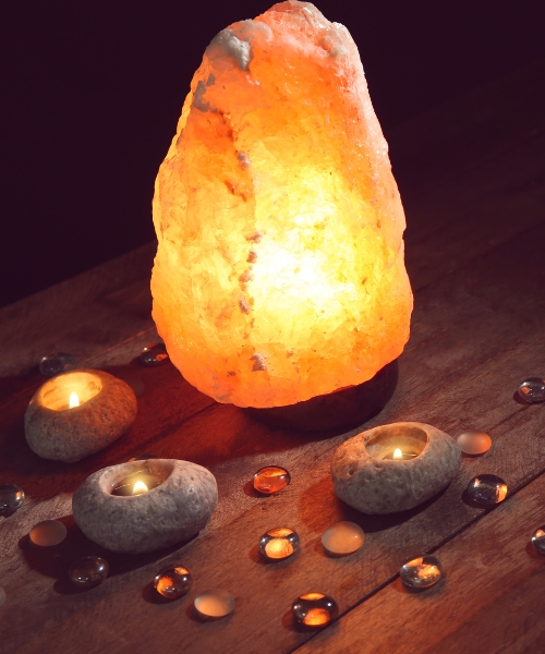 Salt lamp on display with candles